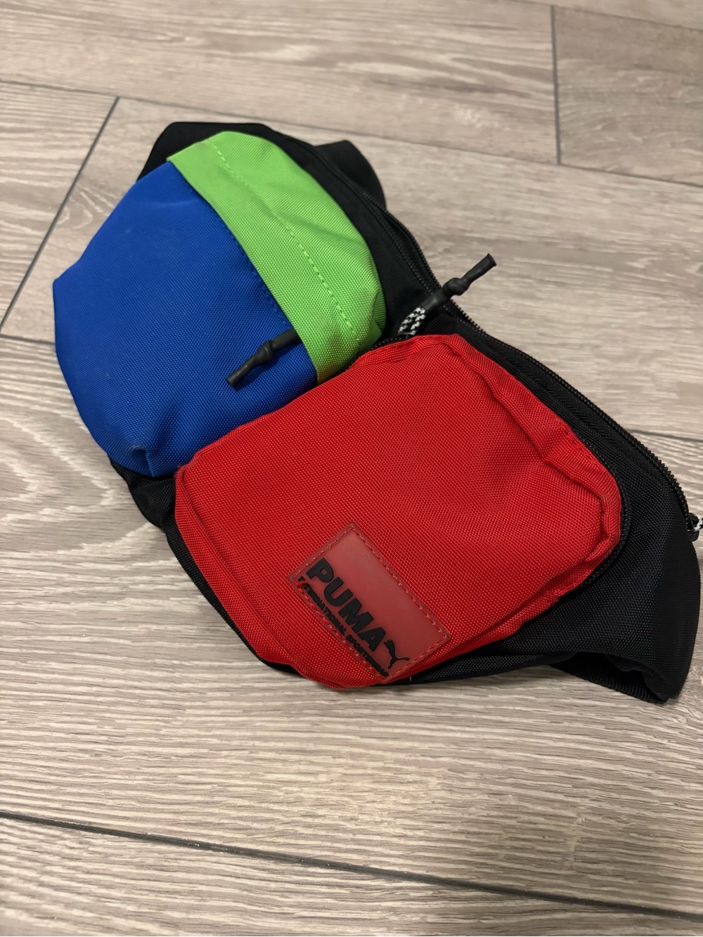 PUMA Unisex Momentum Waist and Shoulder Pack Bag (Black/Red/Blue/Green)